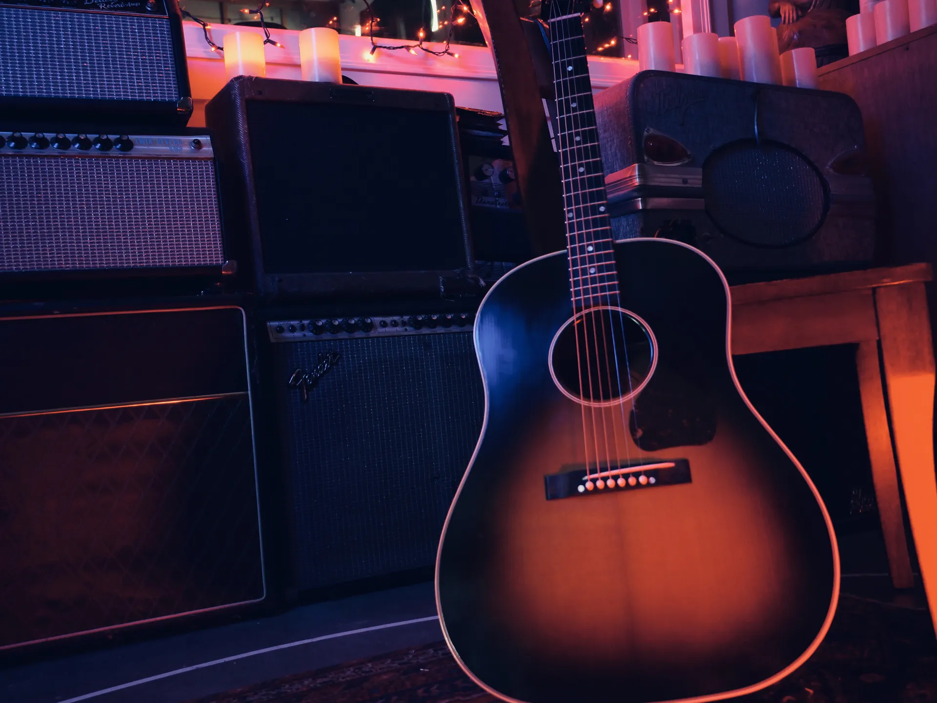 An acoustic guitar and recording equipment pictured in the official music development log.